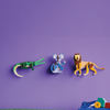 Toy figures of a crocodile, mouse, and lion on a green surface with a purple background